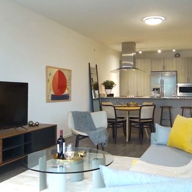 Optima Sonoran Village - Living Room with Cozy Couch and Kitchen View