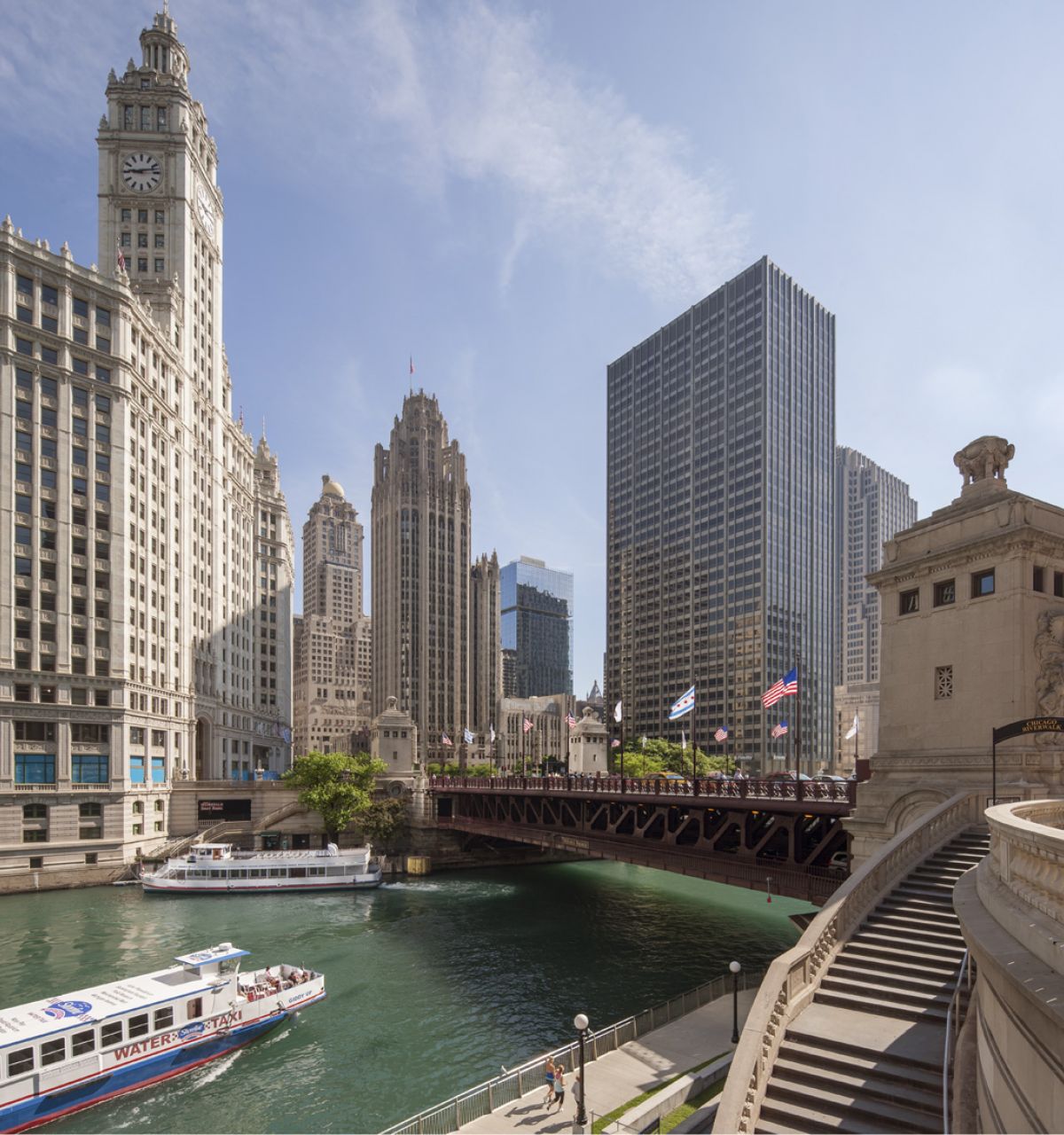 A tour boat glides through the Chicago River, blue space and downtown skyscrapers inspiring mental wellness under a clear sky.