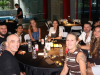 A group of people sitting around a round table at an evening event.