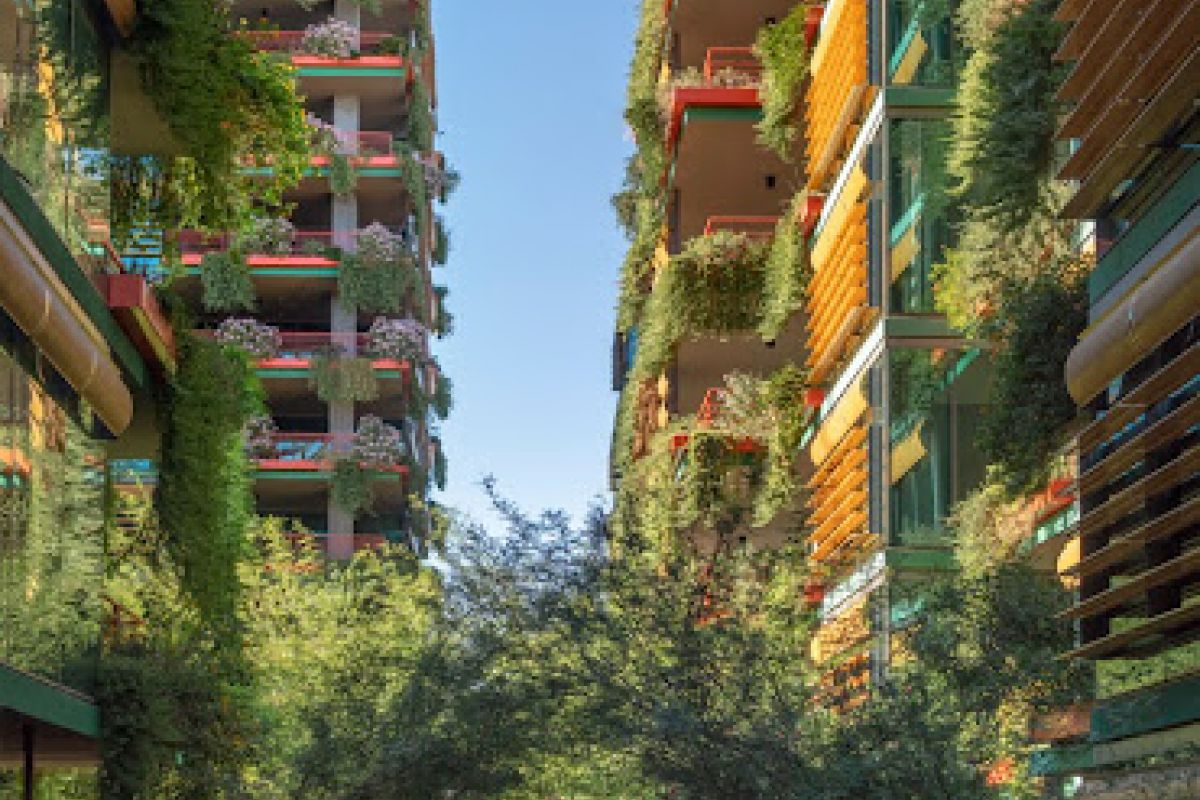 A person walks a dog between tall Scottsdale apartment buildings covered in lush greenery under a clear blue sky.