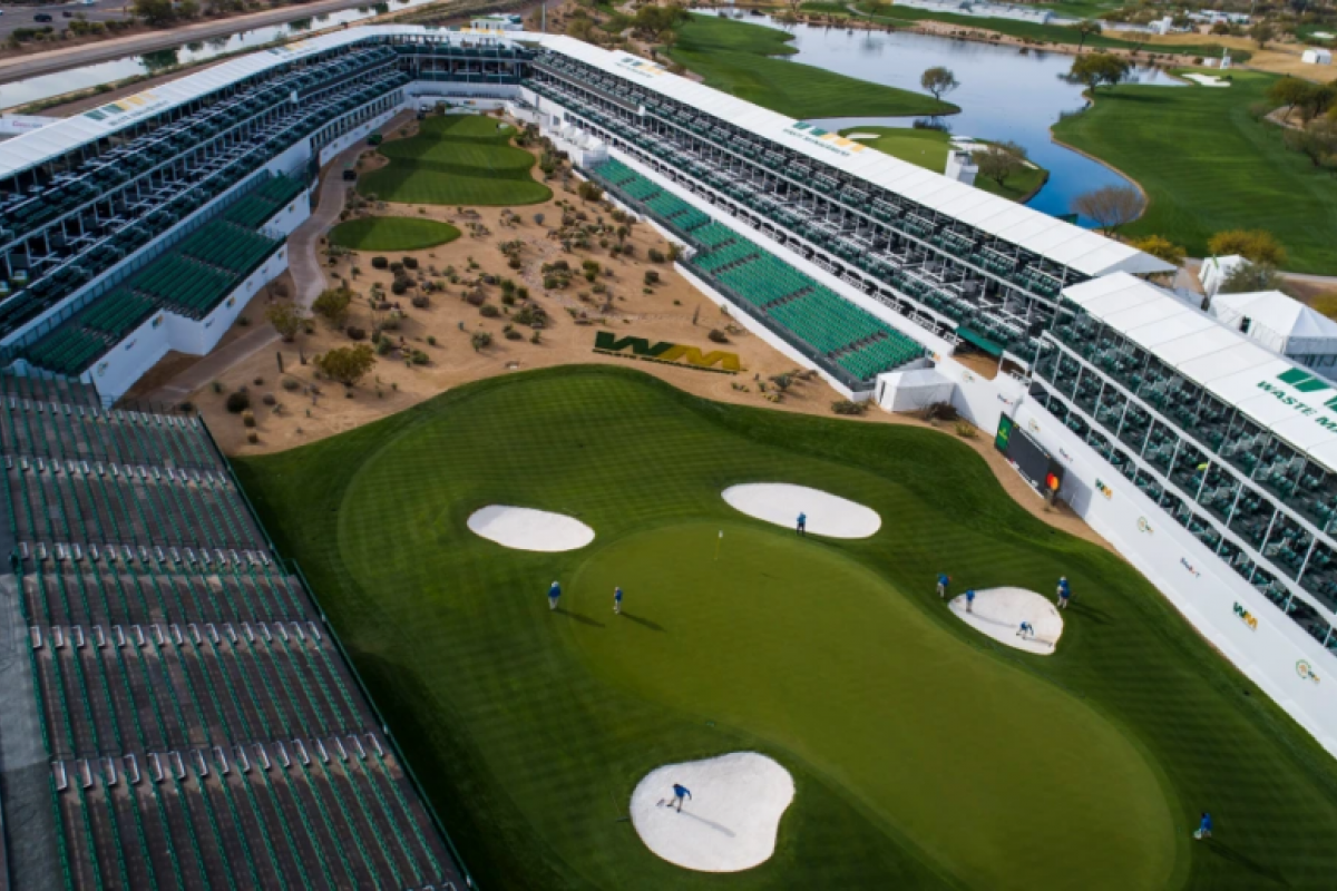 Aerial view of the Phoenix golf tournament green at the Waste Management Phoenix Open, with stadium seating and players on the course.