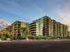 Modern multi-story apartment buildings, common features of Optima Portfolio living, with balconies and greenery at sunset.