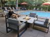 Resident Stories: Bob McMillan enjoys a cozy evening by the fire pit at Optima Sonoran Village with poolside views and orange umbrellas.