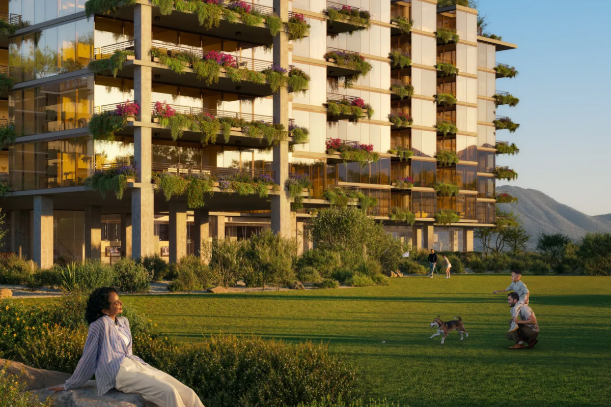 Modern apartment building with plants on balconies; inspired by Japanese philosophy, people unwind and walk a dog on the green lawn at sunset.