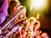 Close-up of saxophone players performing on stage under bright, warm lights at the 2025 Scottsdale Jazz Festival this spring.
