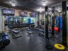Modern fitness center with weight machines, benches, dumbbells, mirrors, and TVs—perfect for your daily habit.
