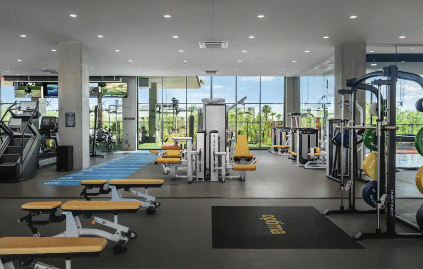 Optima modern gym with yellow and white benches, exercise machines, and large windows—perfect for your Winter Wellness routine.